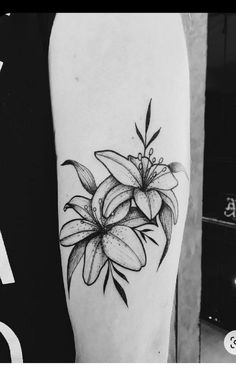 a black and white photo of a flower on the arm