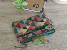 a wallet and some coins on a table