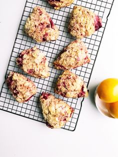 muffins cooling on a wire rack next to an orange