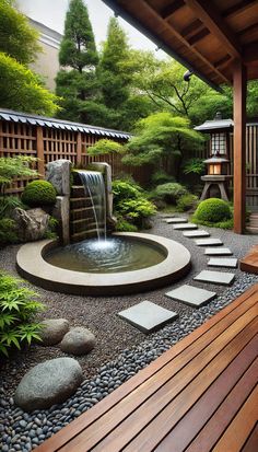 a japanese garden with rocks and water features a small waterfall surrounded by stepping stones that lead into the pond