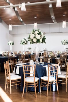 the tables are set with blue linens and white flowers