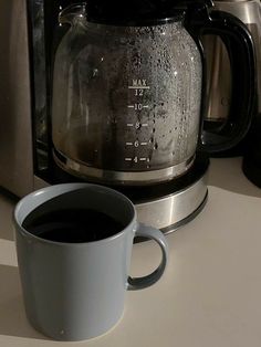 a cup of coffee sitting next to a toaster