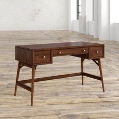 a wooden desk with two drawers on the top and one drawer at the bottom, in an empty room