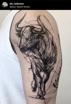 a man with a bull tattoo on his arm