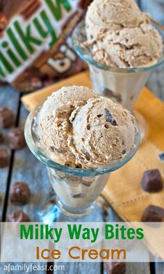 two glasses filled with ice cream on top of a wooden table next to chocolate chips