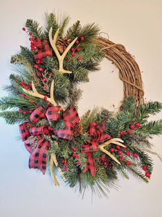 a christmas wreath with antlers and red berries