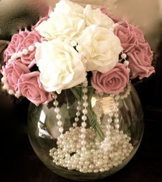 a vase filled with white and pink flowers