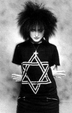 a woman with long hair wearing a star of david t - shirt in black and white