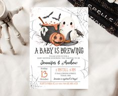 a baby is brewing halloween party with pumpkins and bats