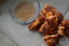 some fried food is next to a bowl of sauce