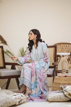 An Uber cool Ice blue ombré in-house printed raw silk shirt and dupatta. All feminine details of Pearls all over the shirt with hand-worked buttons. Our signature sleeve hem style is finished with pearl tassels and our in-house embroidered fabric. The daman is beautifully done with our appliquéd in-house embroidery. Printed dupatta in cool refined colors is finished off with laces and plain pants. House Embroidery, Pearl Tassels, Plain Pants, Printed Dupatta, Feminine Details, Embroidered Fabric, Hem Style, Blue Ombre, Raw Silk