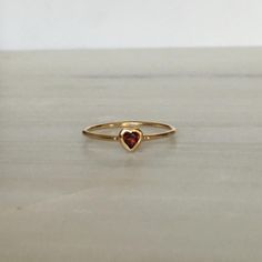 This Garnet Heart Ring brings love with you wherever you go. Show someone you love that you always have them in your heart. A great gift ring! Details: 14k gold (available in yellow, rose or white gold)Garnet heart measures about 3mm Free Shipping on Domestic Orders Materials: Garnet, 14k gold Need your ring bigger tha Heart-shaped 14k Gold Ruby Promise Ring, 14k Gold Red Heart Ring For Promise, Red 14k Gold Heart Ring For Promise, Red 14k Gold Heart Promise Ring, Vintage Heart Ring, Red Heart Ring, Garnet Heart, Vintage Heart, Gift Ring