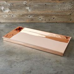 an empty wooden tray on a concrete floor