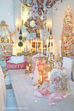 a dining room decorated for christmas with candles and ornaments on the table in front of it