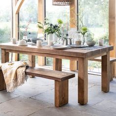 a wooden table and bench in a room