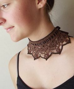 a woman wearing a brown lace collar necklace