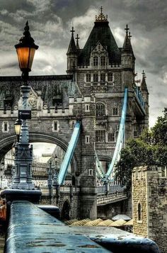 an old photo of the tower bridge in london, england taken on a cloudy day