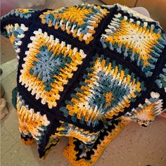 a crocheted blanket sitting on top of a table