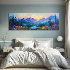 a large painting on the wall above a bed in a room with white sheets and pillows