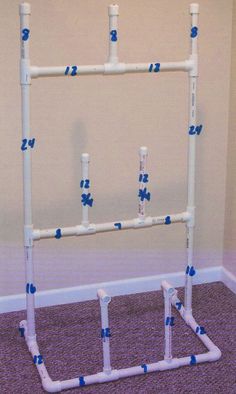 a white pipe rack with blue and white piping on the wall next to a purple carpeted floor