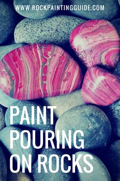 some rocks that have been painted pink and white with the words paint pouring on them