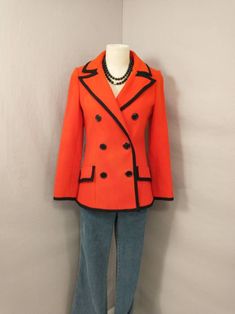 "Vibrant red wool jacket with black trim. Classic styling. Button front. Great for holiday wear. Condition is good, no excess wear but - has fading back of right sleeve and many marks. May improve with dry cleaning but no odor and may have been attempted already. Label is French Shop. Super quality. Circa early eighties. Shown on an 6 mannequin. Measurements - Length 27\" Shoulder 16\" Bust 36/37\" Waist 32\" Hem circumference 43\" Sleeve length 24.5\" Wt 2.5lbs 3 to ship" Classic Fall Blazer With Contrast Trim, Classic Blazer With Contrast Trim For Fall, Fall Blazer With Contrast Trim And Long Sleeves, Office Outerwear With Contrast Trim For Fall, Fall Office Outerwear With Contrast Trim, Tailored Outerwear With Contrast Trim For Fall, Fitted Fall Outerwear With Contrast Trim, Fitted Outerwear With Contrast Trim For Fall, Dress Styling