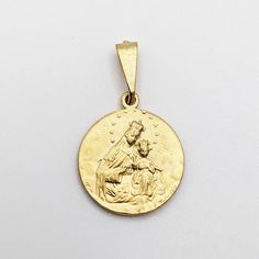 "This lovely medal of Our Lady of Mount Carmel is made of 18K gold vermeil and measures 20mm in diameter. The reverse of the medal has an image of the Sacred Heart of Jesus. OUR LADY OF MOUNT CARMEL, or Virgin of Carmel, is the title given to the Blessed Virgin Mary in her role as patroness of the Carmelite Order. The first Carmelites were Christian hermits living on Mount Carmel in the Holy Land during the late 12th and early to mid-13th century. They built in the midst of their hermitages a ch Yellow Gold Medallion For Commemoration, Yellow Gold Coin Pendant For Commemoration, Round Coin Pendant For Commemoration, 14k Gold Medallion For Commemoration, St Simon Stock, Our Lady Of Mount Carmel, Mount Carmel, Sacred Heart Of Jesus, Heart Of Jesus