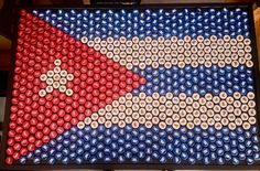 a beer bottle art made to look like the flag of cuba with red, white and blue bottles