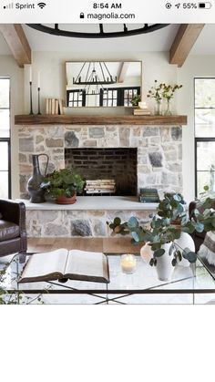 a living room filled with furniture and a fire place in front of a stone fireplace