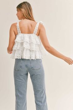 Summer love is in the air with this Embroidered Tier Top. With its playful sleeveless design, ruffle tiered lace, and delicate lace shoulder straps, it's the perfect addition to any warm weather wardrobe. Bring out your inner romantic in this flirty and feminine babydoll top.