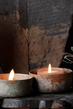 three candles sitting on top of a wooden table