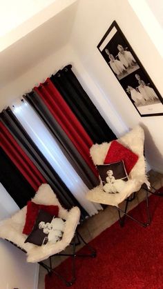 two chairs sitting on top of a red rug