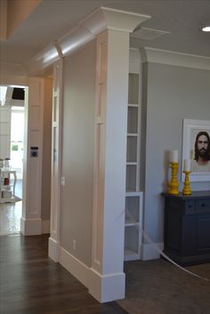 an empty living room with white walls and wood floors