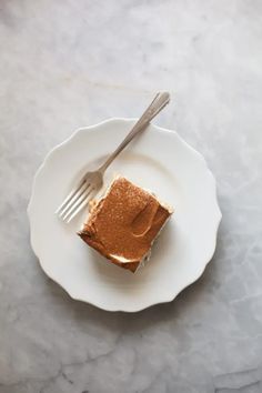 a piece of cake sitting on top of a white plate with a fork in it