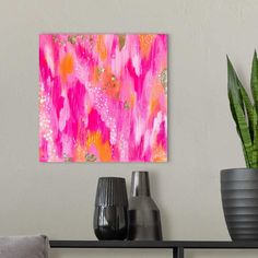 a pink and orange painting on a wall next to two vases with plants in them