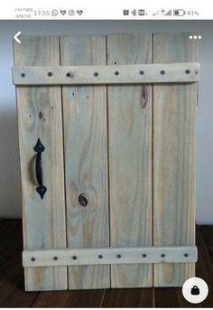 an image of a wooden box with metal knobs on it's front door