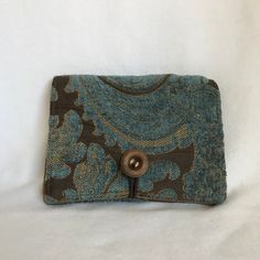 Tiny wallet, perfect for smaller handbags. Small wallet in French Blue chenille with gold and brown accent. Gold tone lining. Closes with vintage button and elastic loop. Features easy access zippered coin pocket on the back with space behind coin pocket for cards and paper bills. Wallet measures 4 1/2 inches wide X 3 1/2 inches when closed, 4 1/2 inches wide X 7 1/4 inches when open. 2 inside pockets for cards and cash. Handcrafted in Vermont, USA Vintage Blue Wallets For Everyday Use, Blue Vintage Wallets For Everyday Use, Vintage Bifold Coin Purse For Travel, Vintage Handmade Brown Pouch, Handmade Brown Vintage Pouch, Vintage Wallets With Snap Closure, Vintage Wallets With Snap Closure For Everyday Use, Vintage Blue Rectangular Wallets, Vintage Blue Rectangular Wallet