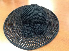 This designer vintage hat is the perfect spring/summer accessory. It is black crochet with crochet applique Size: Approximately size Small/Medium, Brand: Carolina Amato, Made in Italy Condition: Excellent Black Vintage Sun Hat For Beach, Black Bohemian Straw Hat For Spring, Black Crochet Yarn Hat, Vintage Black Straw Hat For Beach, Vintage Black Straw Beach Hat, Black Crochet Hat One Size Fits Most, Black Crochet Brimmed Hat, Black Adjustable Crochet Hat, Black Handmade Flat Brim Sun Hat