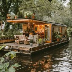 a houseboat is floating on the water with plants in it's deck area