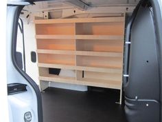 the back end of a van with shelves in it