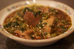 a white bowl filled with meat and vegetables