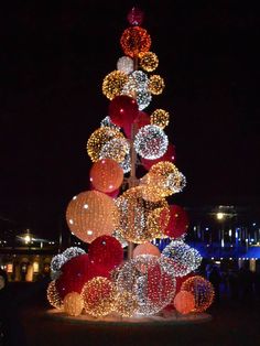 a lighted christmas tree with balls and lights on it