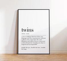 a black and white poster with the words twins on it in front of a wall