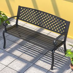 a bench sitting next to a potted plant on top of a tiled floor in front of a yellow wall