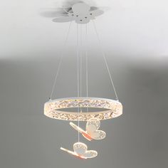 a chandelier hanging from the ceiling with toothbrushes and other items in it