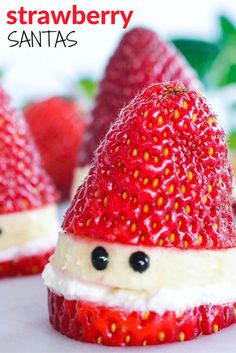 some strawberries are decorated like santas and have faces made out of the fruit