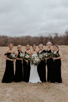 a group of women standing next to each other in a field