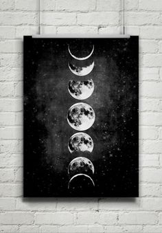 three phases of the moon against a black background with white brick wall hanging on it