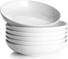 a stack of white bowls sitting on top of each other