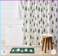 a white shower curtain with green trees on it and a stool in front of it